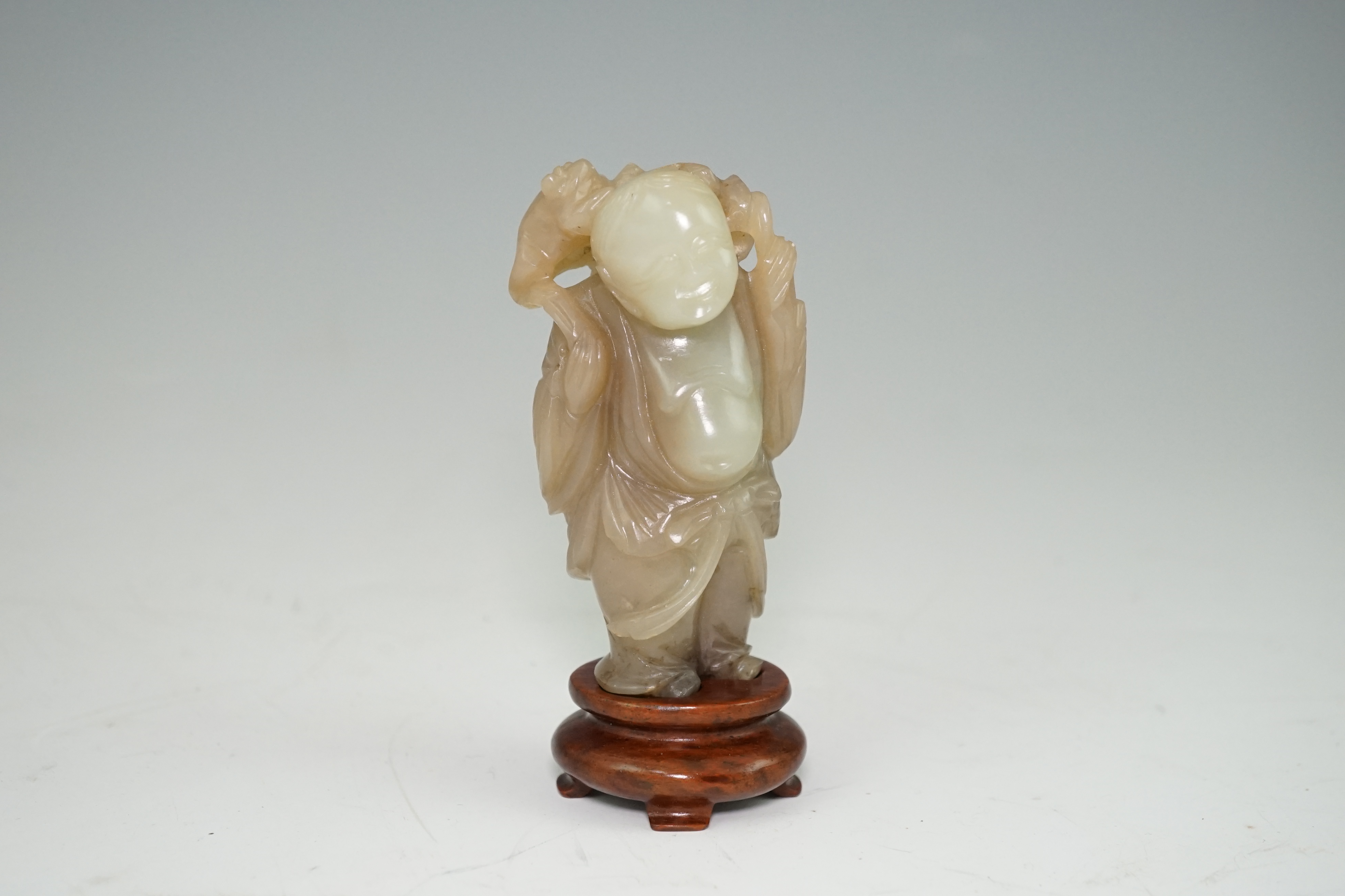 A Chinese pale celadon and brown jade group of Liu Hai and his three legged toad, Qianlong period (1736-95)